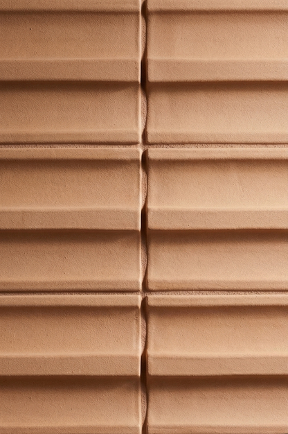 Terracotta ribbed clay tile by Clay Imports, with distinct horizontal ridges and textured surface.