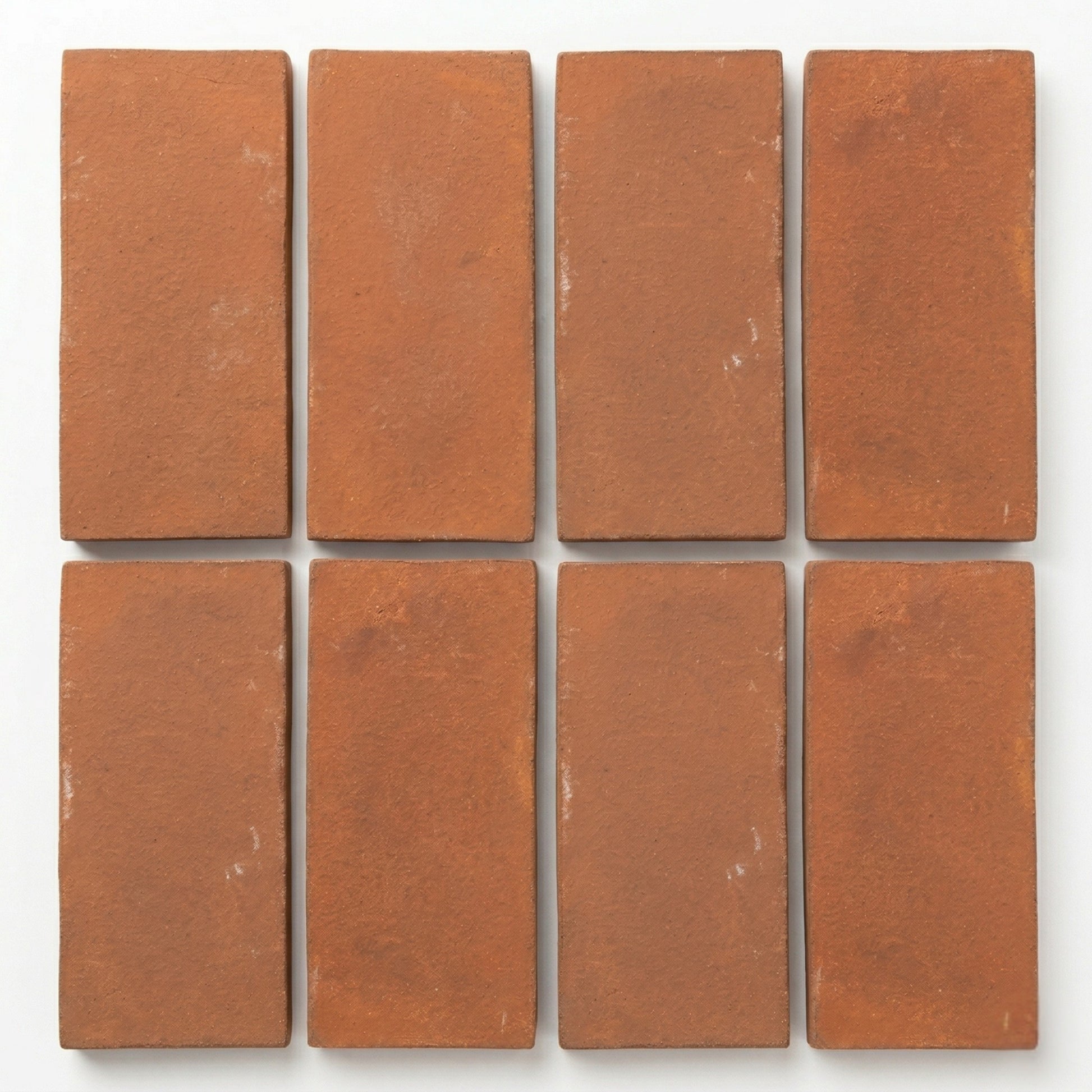 Umber Cotto tiles by Clay Imports, displaying a rustic texture in a rectangular arrangement.