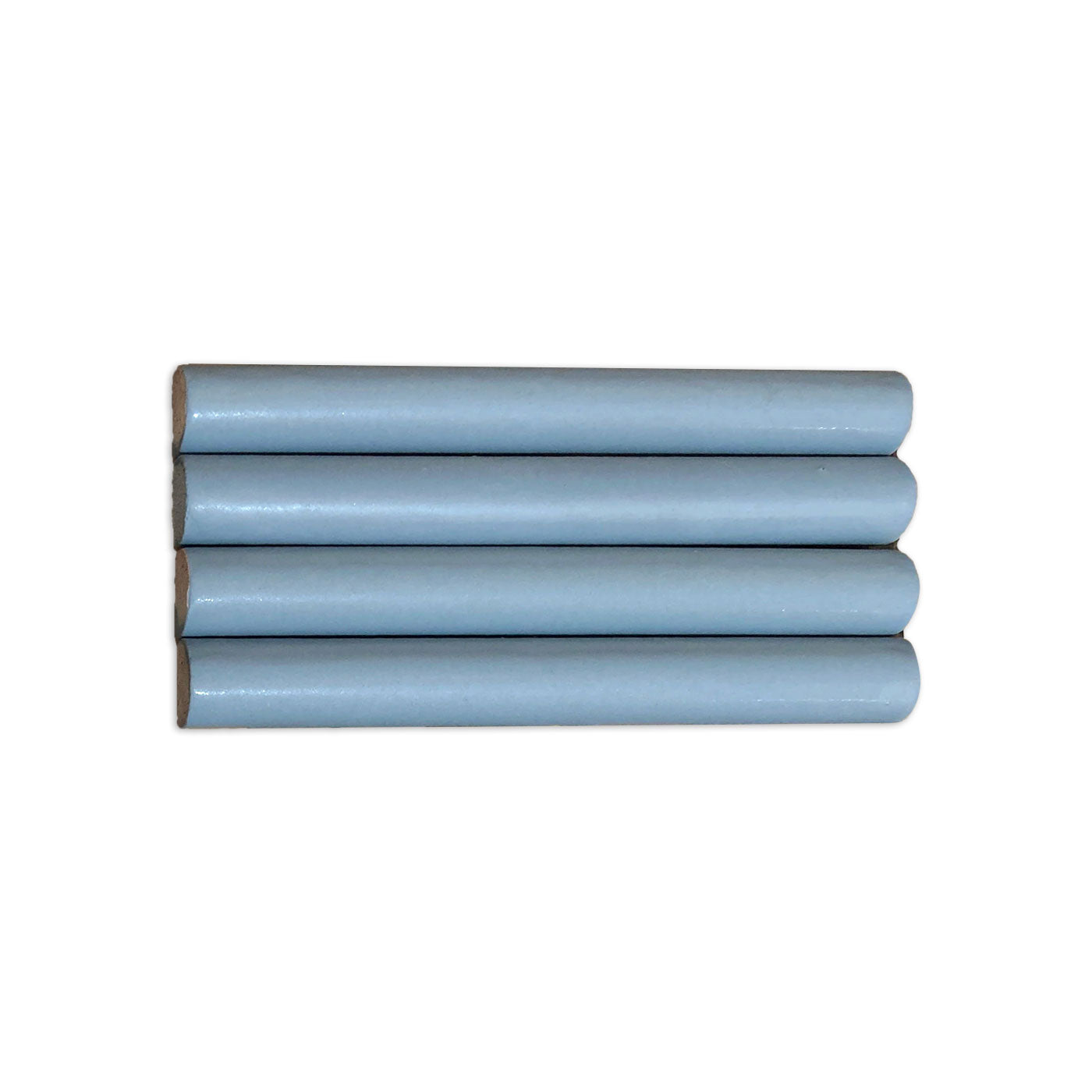 Light blue pencil liner tile by Clay Imports, with four pieces stacked horizontally showing natural exposed edges.
