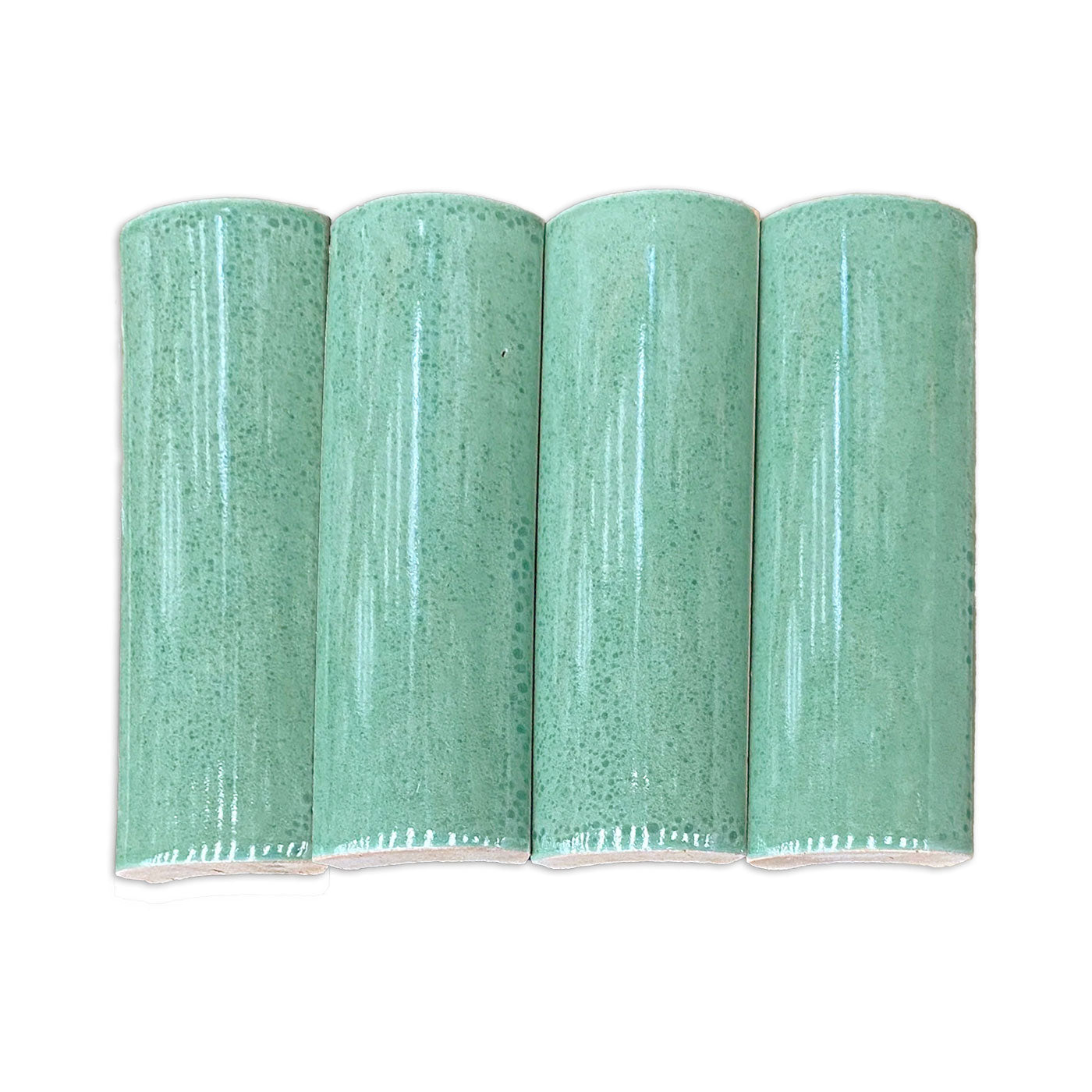 Quarter Round Jade solid tile by Clay Imports, four green pieces with speckled, glossy glaze and rough unglazed bottoms.
