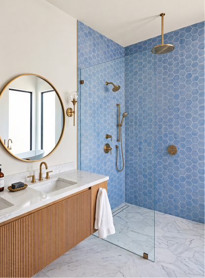 Blue hexagon solid tile from Clay Imports installed on shower walls with white grout in a modern bathroom.