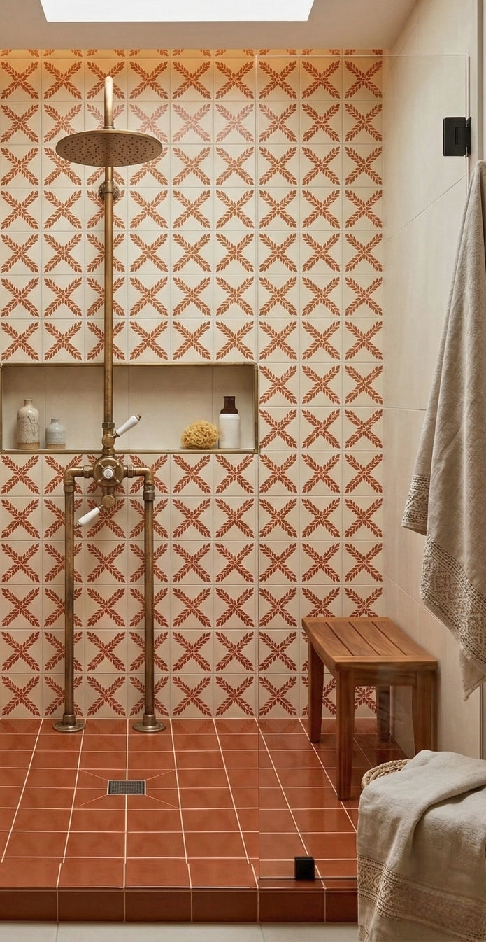 Cream Talavera Arbor tile by Clay Imports Handmade Tile, with a terracotta leaf pattern on a shower wall.