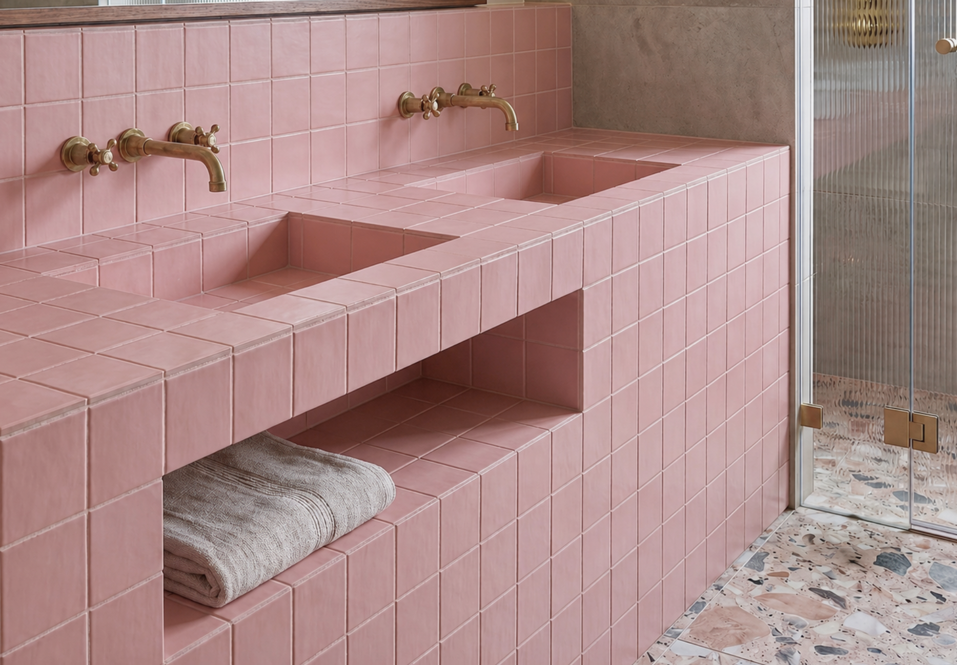 Pink tiled bathroom with a sink and towel
