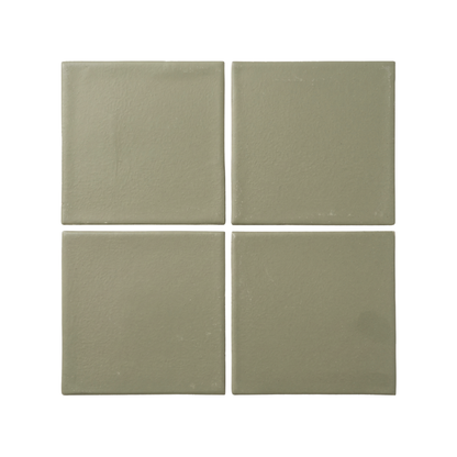 Four square sage green ceramic tiles are arranged in a 2x2 grid against a clean white background.