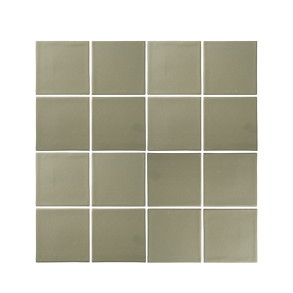 A grid of sixteen sage green square ceramic tiles displays a matte finish and subtle variations in color.