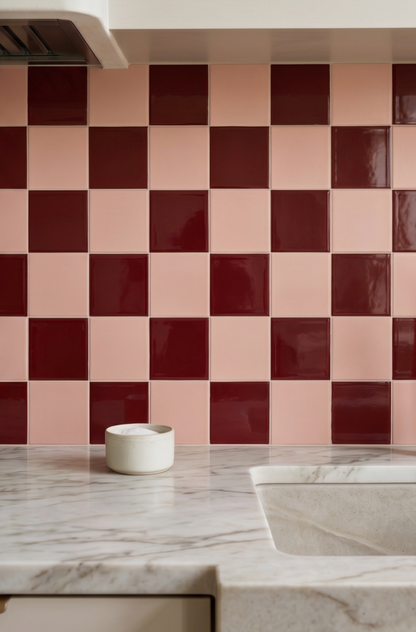 Checkered backsplash with pink and brown tiles in a kitchen setting.