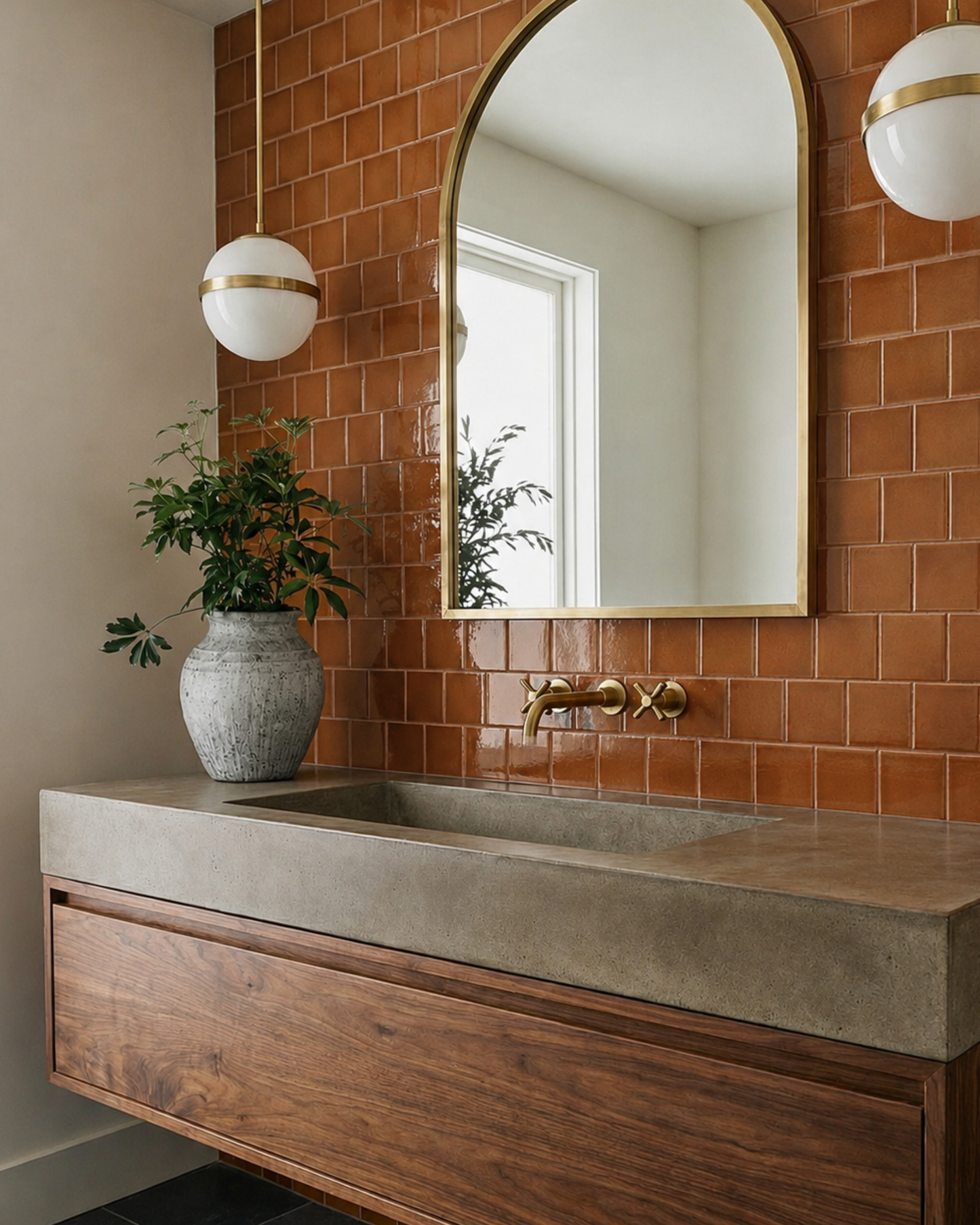 Cajeta 4.25x4.25 glossy solid tile from Clay Imports, showcasing rich burnt orange tones on a bathroom wall.