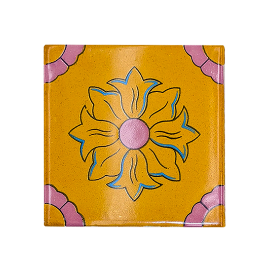 Yellow Talavera tile sample by Clay Imports Handmade Tile with a pink and blue floral design and pink corner accents.