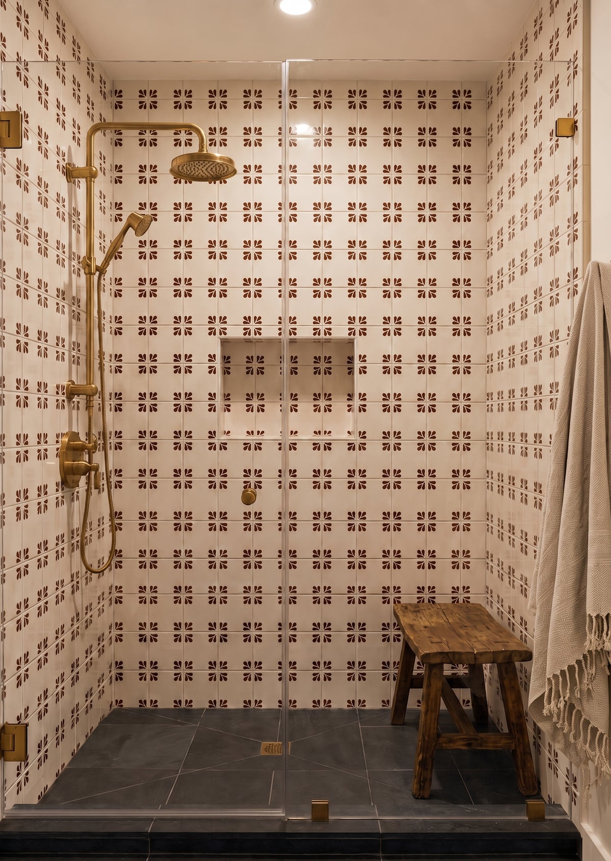 Oxblood Talavera tile by Clay Imports Handmade Tile featuring a Tula pattern on a white background, installed in a shower with brass fixtures.