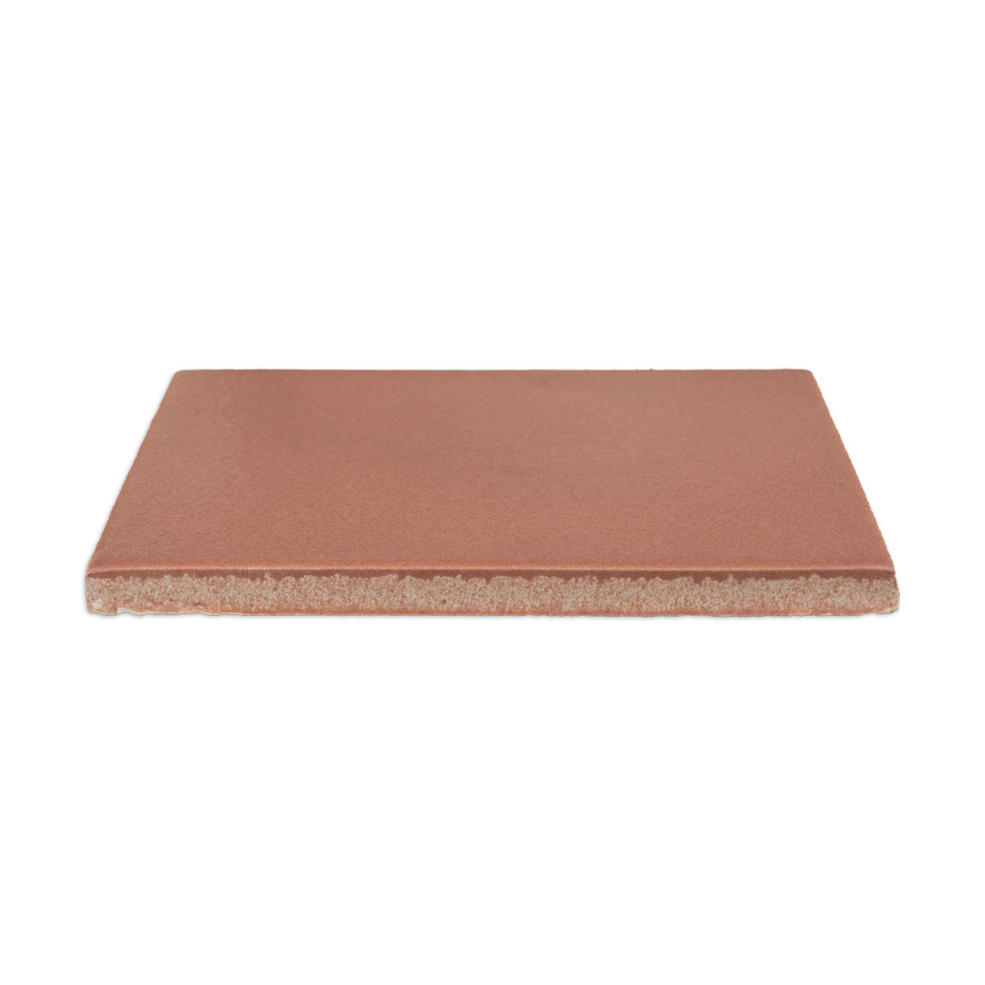 Lava Rock Matte Solid Tile by Clay Imports, reddish-brown with a matte surface and textured, porous bottom layer, viewed from the side.