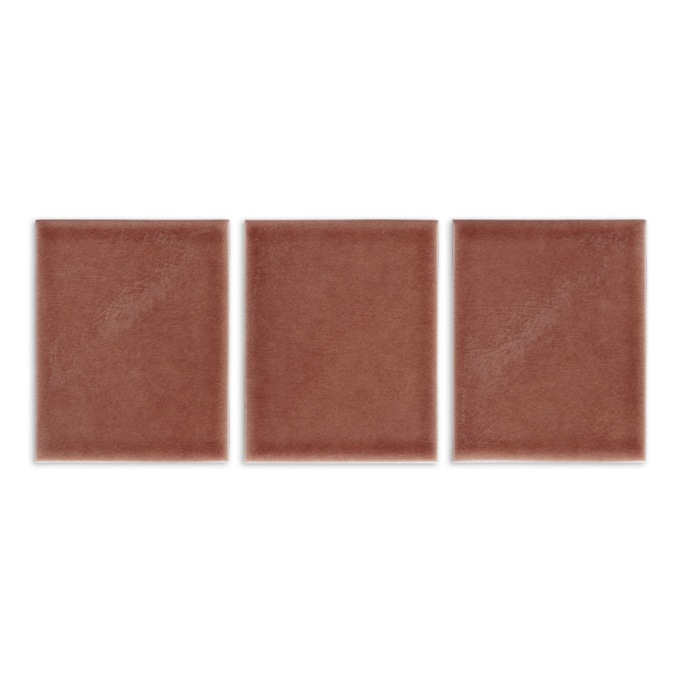 Terracotta brown solid tile by Clay Imports, featuring three square pieces with a subtle mottled texture.