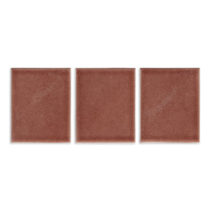 Terracotta brown solid tile by Clay Imports, featuring three square pieces with a subtle mottled texture.