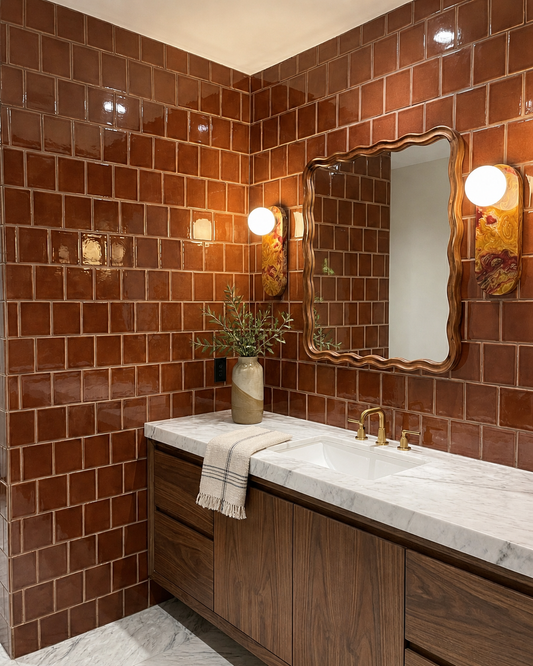 Tamarindo Gloss solid tile by Clay Imports in a subway pattern on a modern bathroom wall.