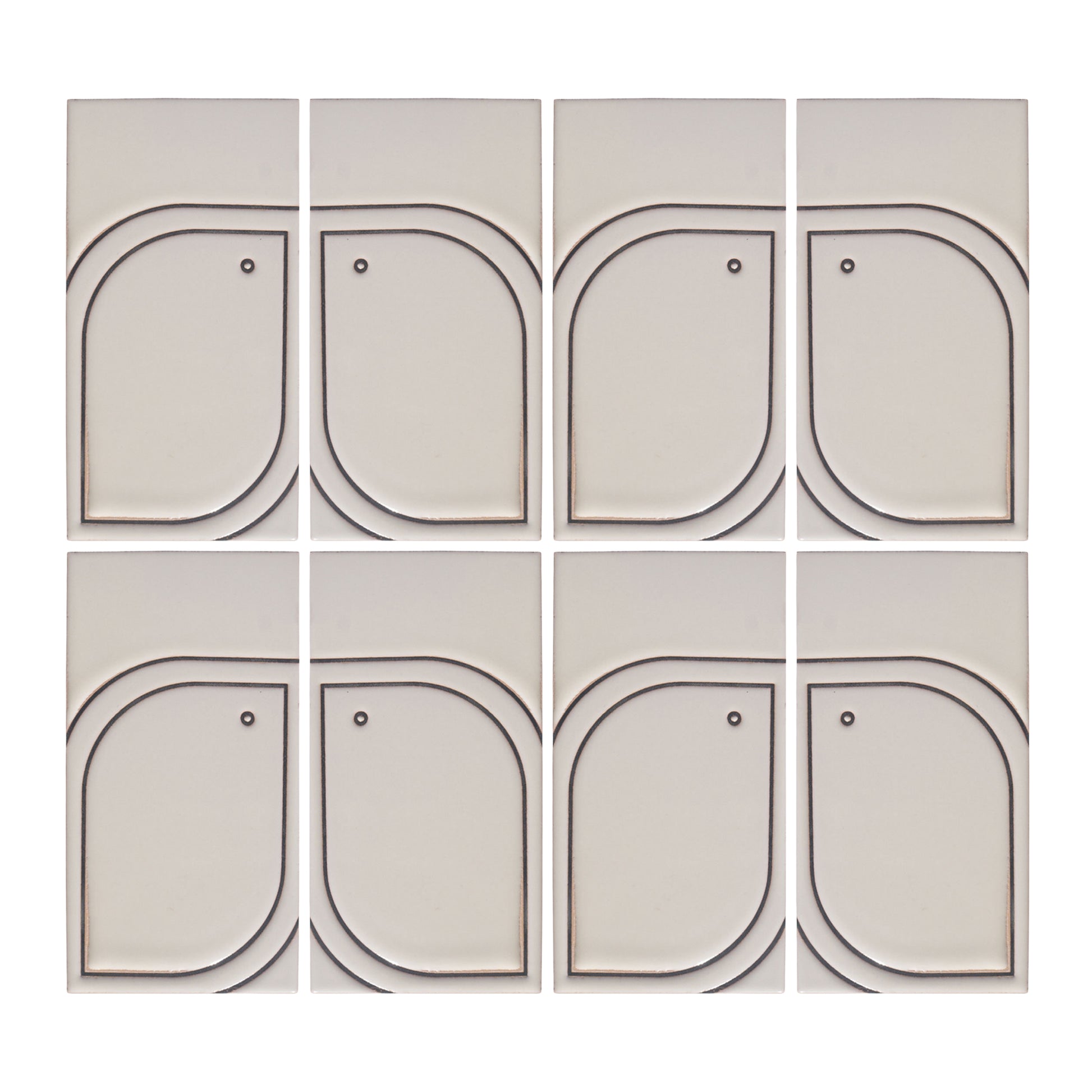 Eight light beige Pio Pio Petit Candela ceramic tiles by Clay Imports, featuring dark curved outlines and small dots.