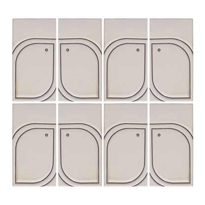 Eight light beige Pio Pio Petit Candela ceramic tiles by Clay Imports, featuring dark curved outlines and small dots.