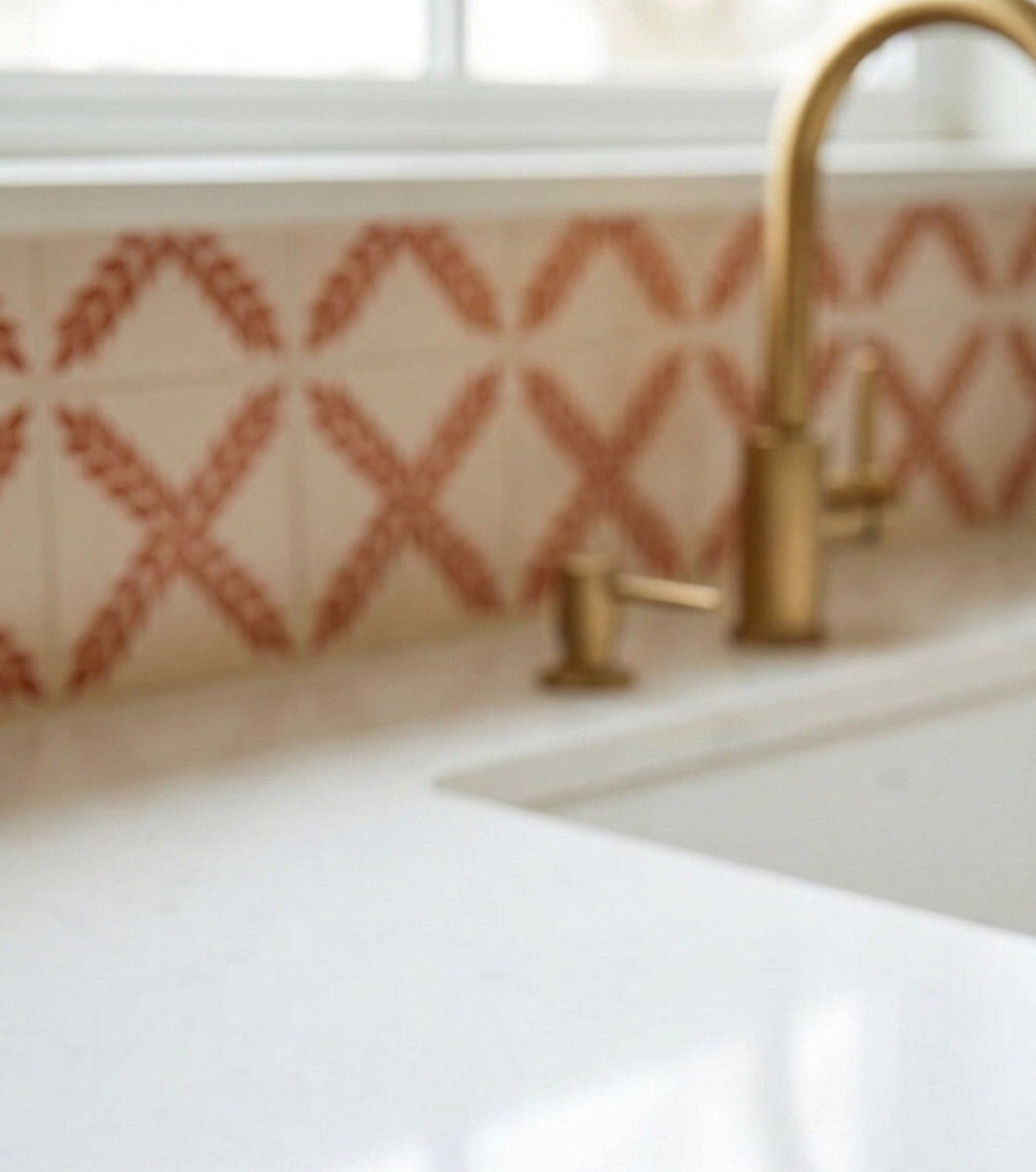 Reddish-brown 'Arbor' pattern Talavera tile by Clay Imports Handmade Tile featuring repeated criss-cross designs on a cream background.