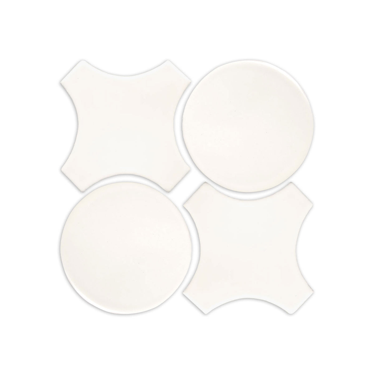 White clay tiles by Clay Imports, featuring two circular and two quatrefoil shapes arranged in a square.