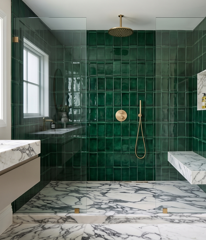 Handcrafted green glazed 4x8 ceramic subway tile by Clay Imports covering a shower wall with gold fixtures and marble accents.