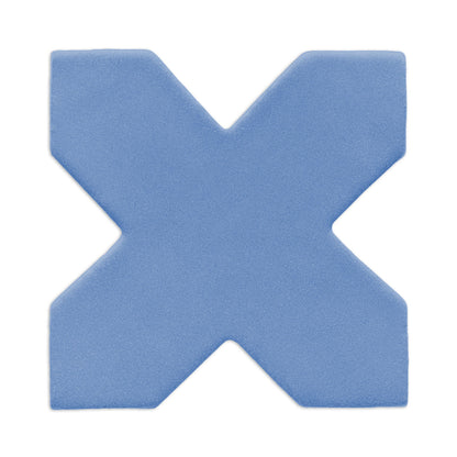 Denim blue X-shaped clay tile by Clay Imports with a subtle granular texture, casting a soft shadow.