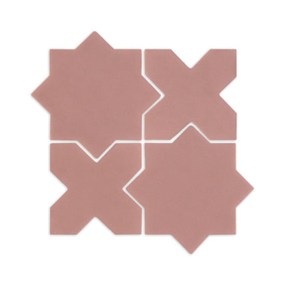 Four pink granite star and cross sample tiles by Clay Imports, showing their interlocking pattern and subtle texture.