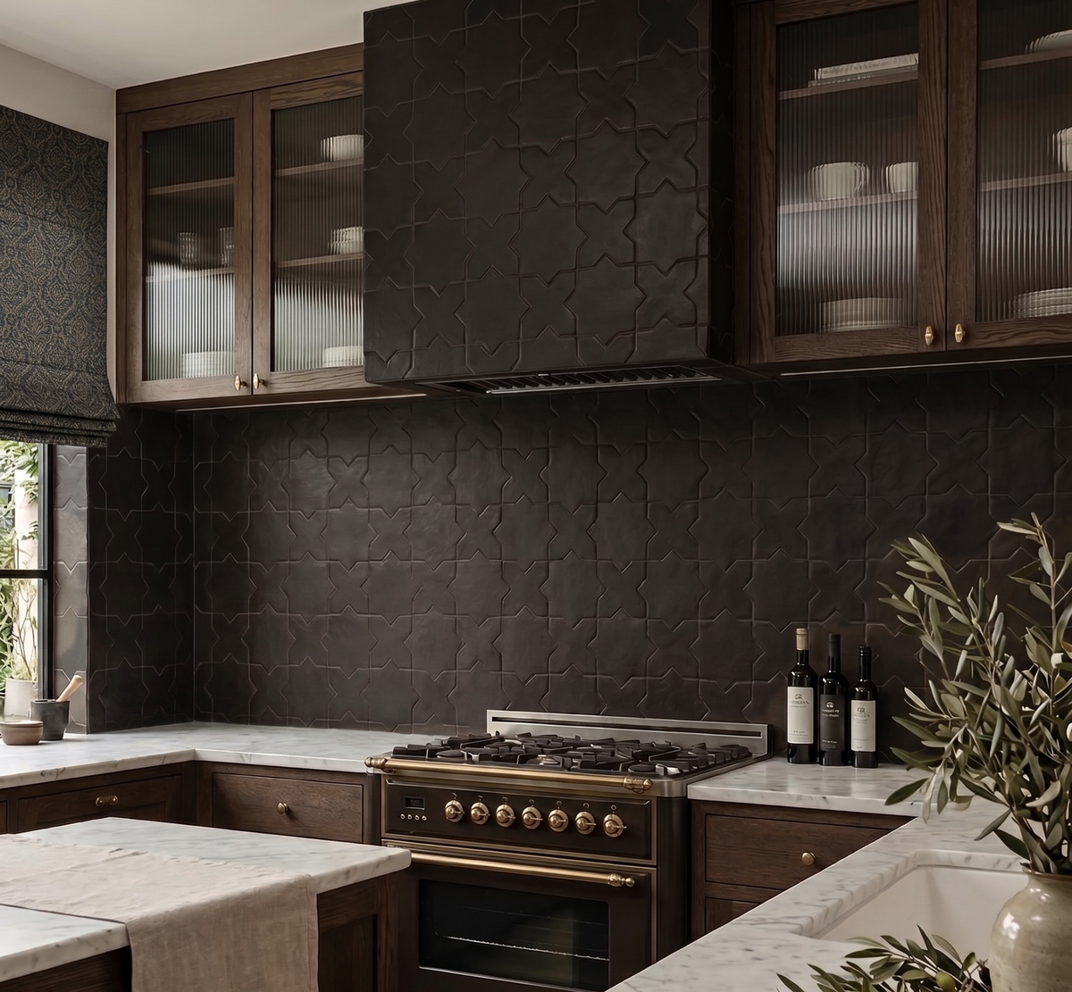 A modern kitchen interior featuring dark textured stone wall tiles, dark wood cabinetry with glass-front upper cabinets, a gas range stove, marble countertops, and decorative plants.