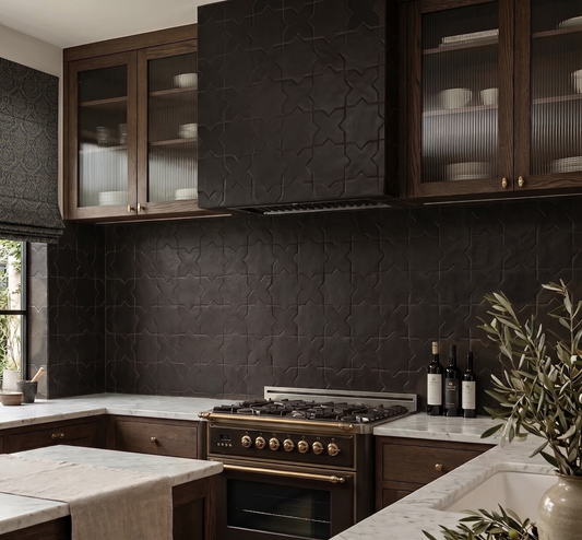 A modern kitchen interior featuring dark textured stone wall tiles, dark wood cabinetry with glass-front upper cabinets, a gas range stove, marble countertops, and decorative plants.