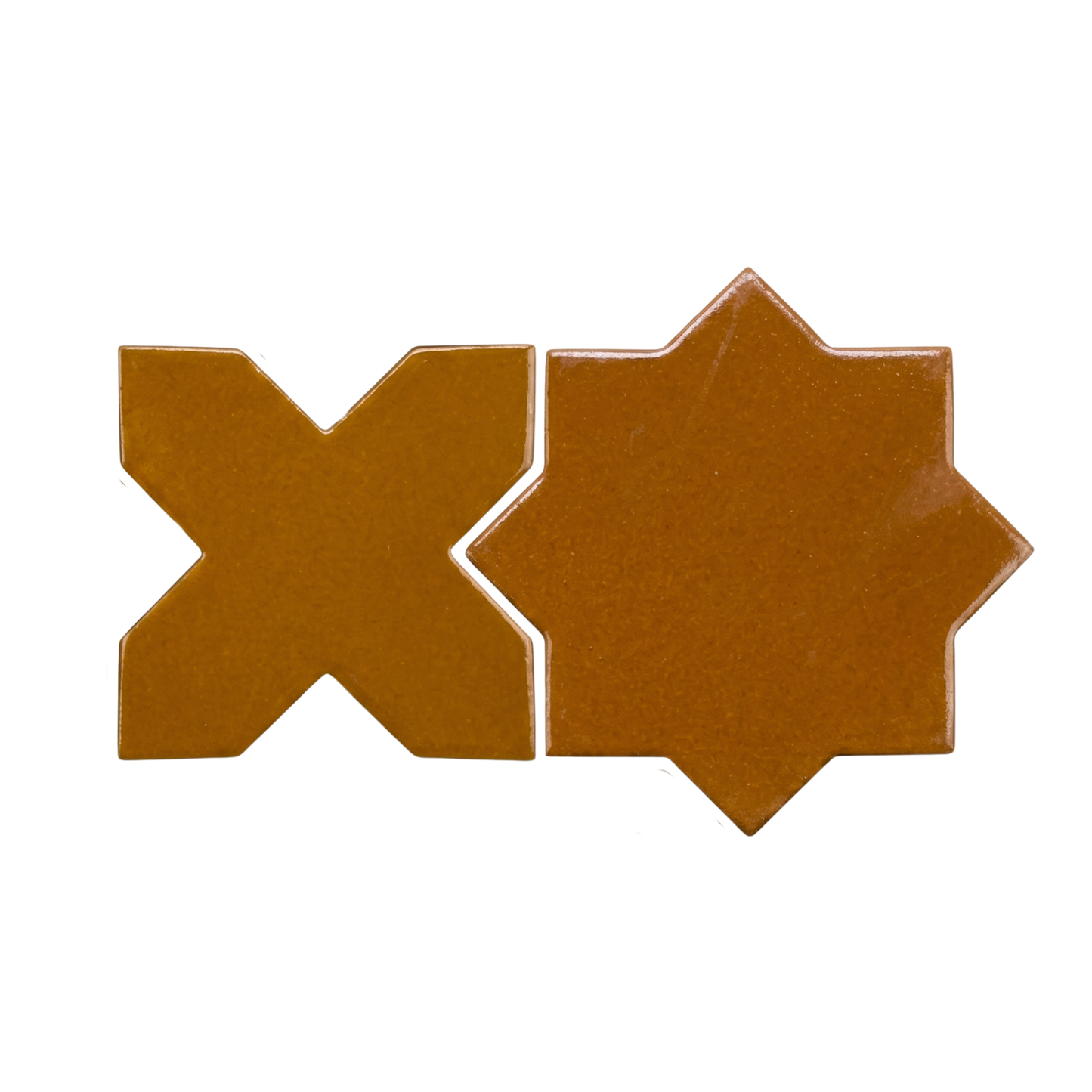 Glossy Cajeta brown star and cross solid tiles by Clay Imports, displayed side by side.