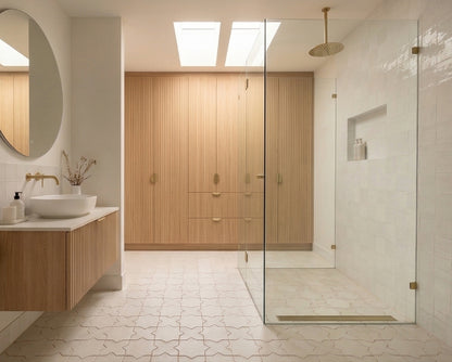 Light beige Star & Cross patterned floor tiles by Clay Imports covering a modern bathroom floor and shower area.