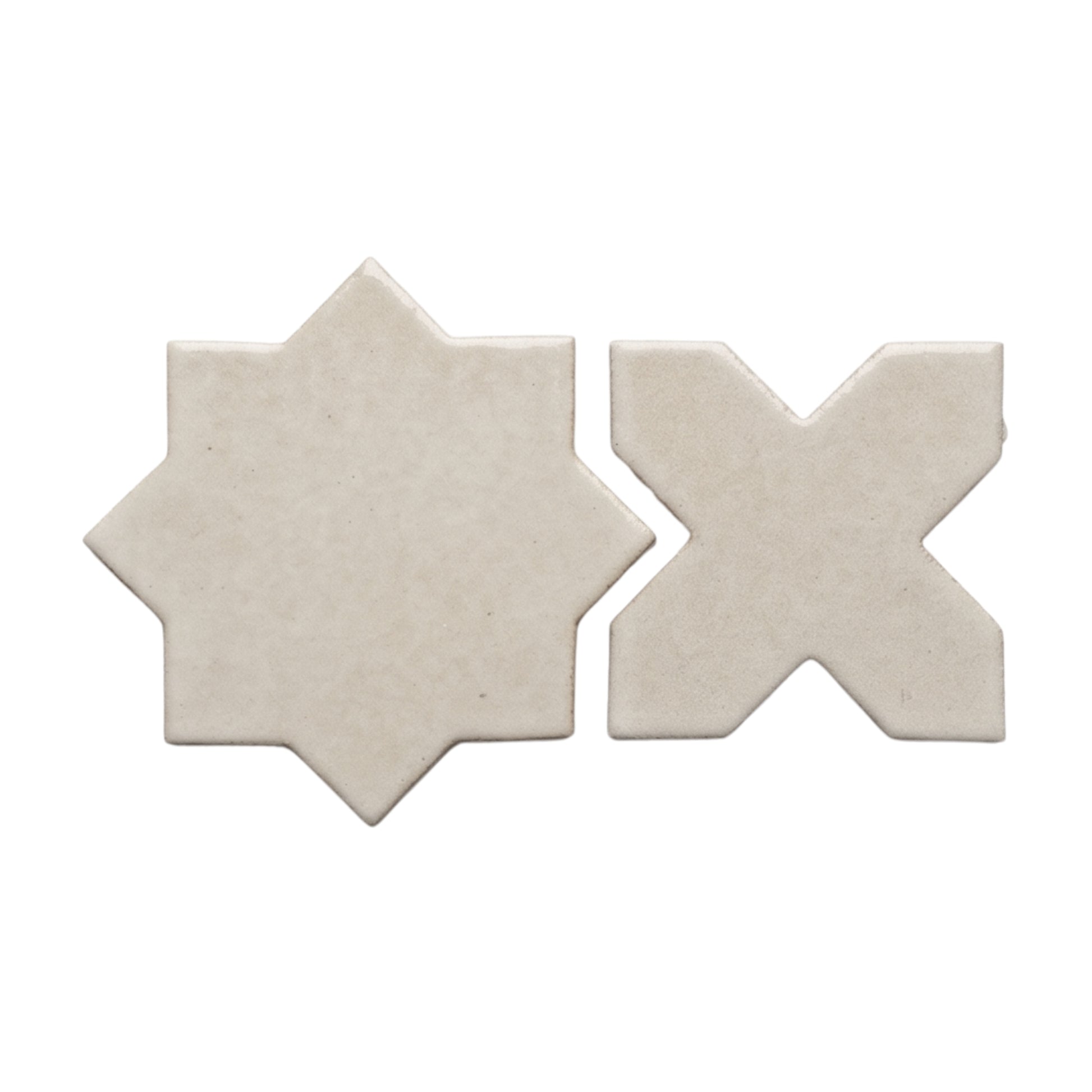 Pearl snap star and cross tiles by Clay Imports with subtle speckling and a glossy finish, isolated on white.