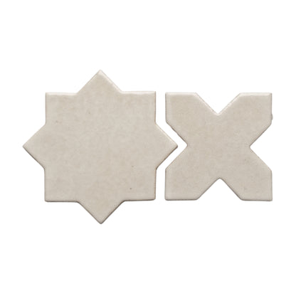 Pearl snap star and cross tiles by Clay Imports with subtle speckling and a glossy finish, isolated on white.