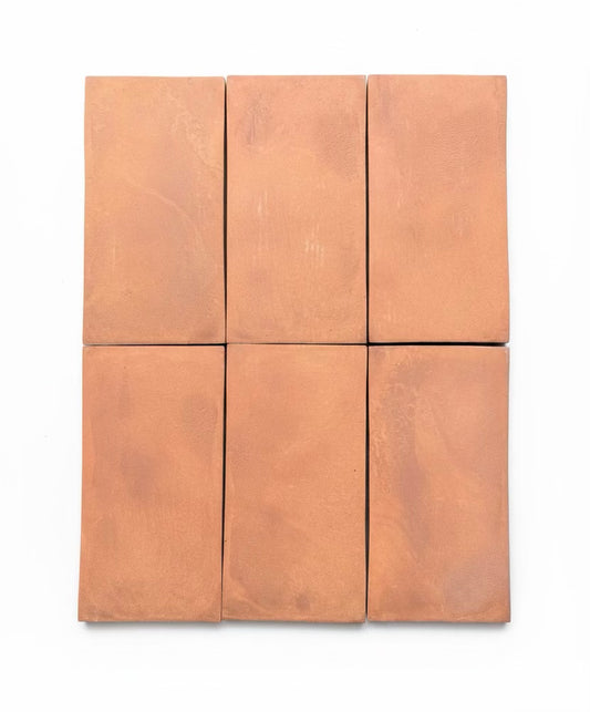 Set of six square tiles with a terracotta color on a white background