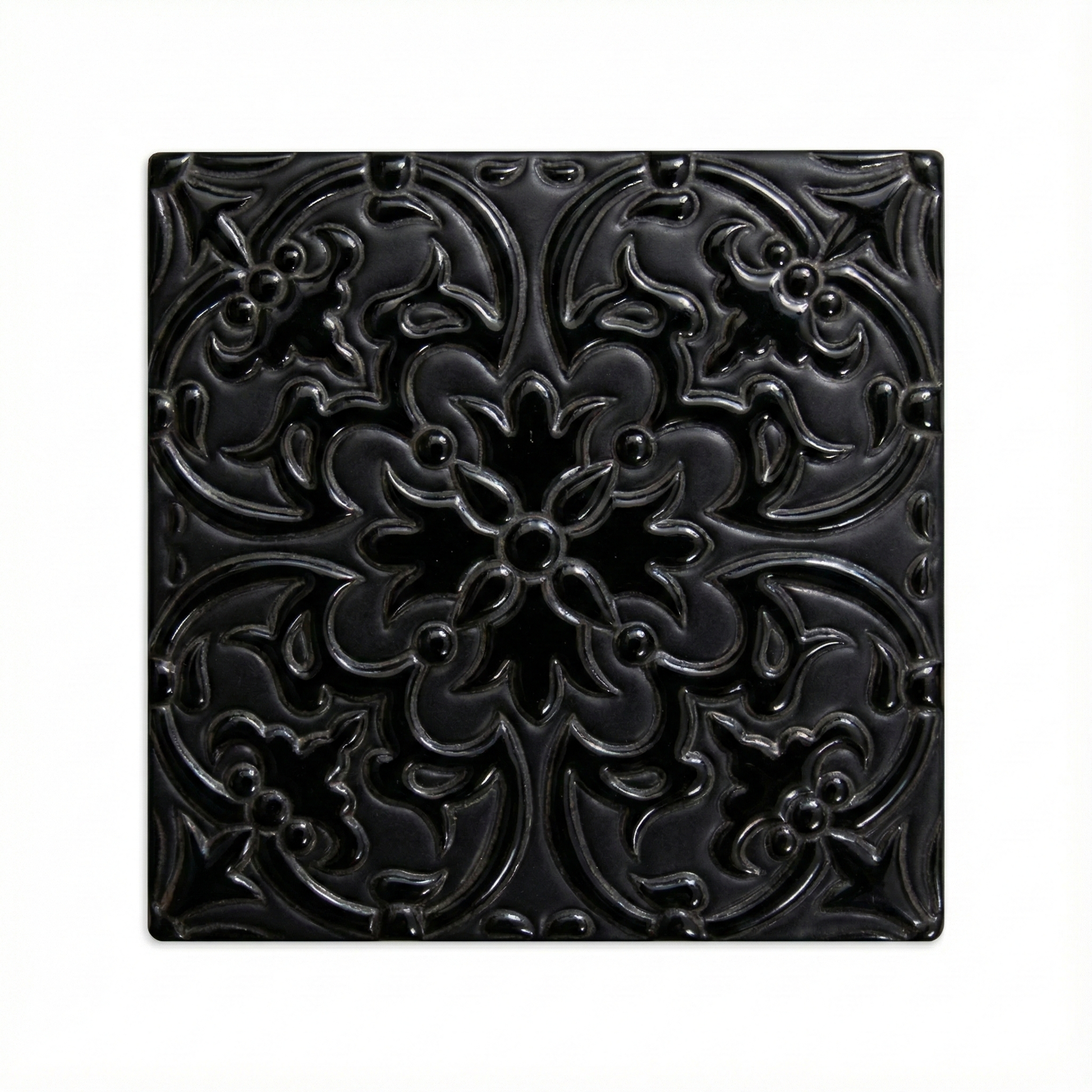 Black relief tile by Clay Imports featuring an ornate raised floral and scroll pattern with a glossy finish.