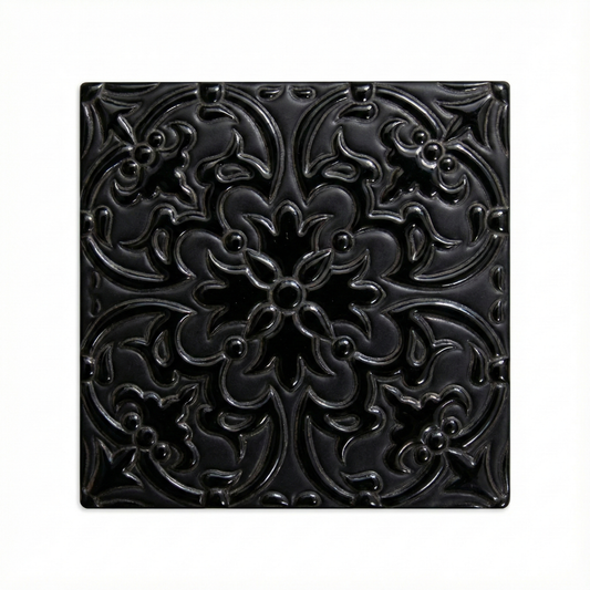 Black relief tile by Clay Imports featuring an ornate raised floral and scroll pattern with a glossy finish.