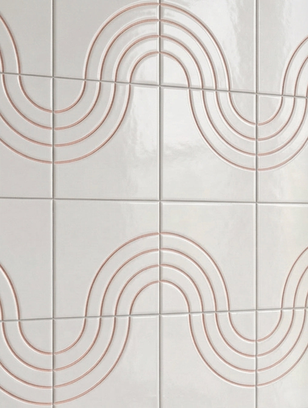 White relief tiles by Clay Imports with a repeating wavy pattern of copper-toned concentric lines on a glossy surface.