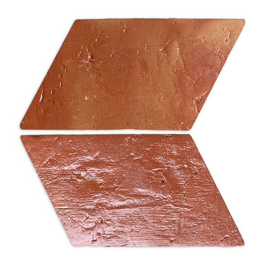 Two reddish-brown parallelogram terracotta tiles by Clay Imports, featuring an antique gloss and textured surface, angled right.