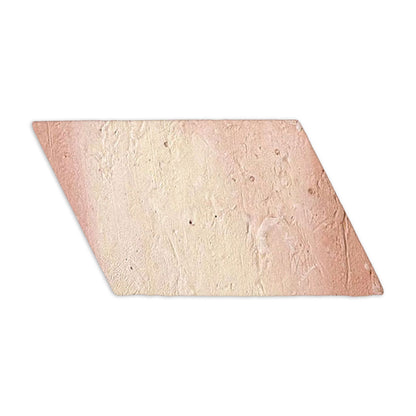 Antique matte terracotta tile in faded reddish-pink and cream by Clay Imports, with a textured parallelogram shape, left side view.