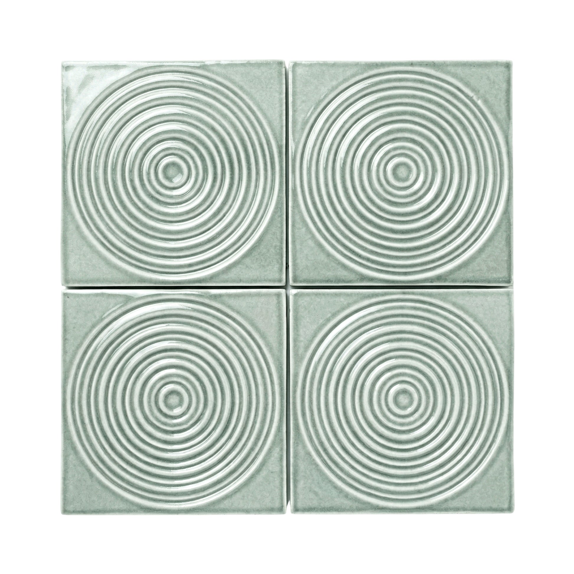 Four Aurora Arctic Gloss tiles by Clay Imports, featuring raised concentric circle patterns.