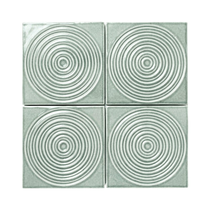 Four Aurora Arctic Gloss tiles by Clay Imports, featuring raised concentric circle patterns.