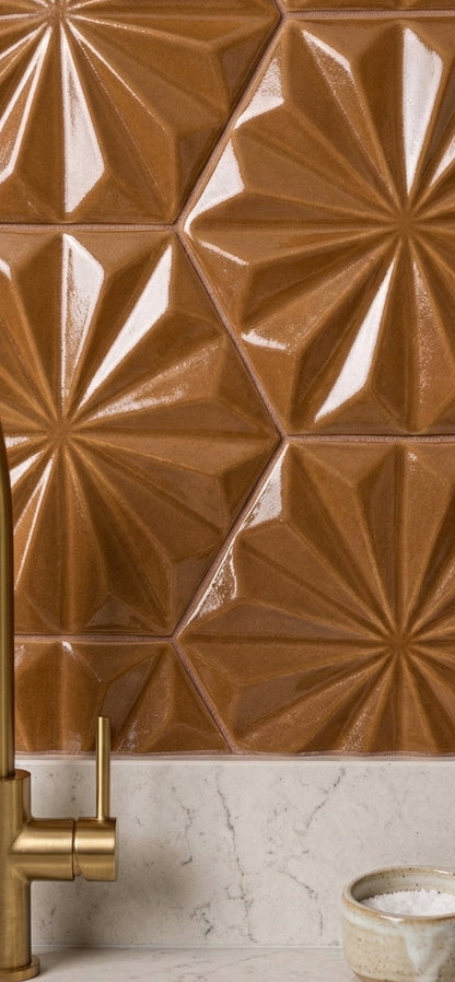 Brown glossy hexagonal solid tile by Clay Imports with a geometric starburst pattern, installed as a kitchen backsplash.