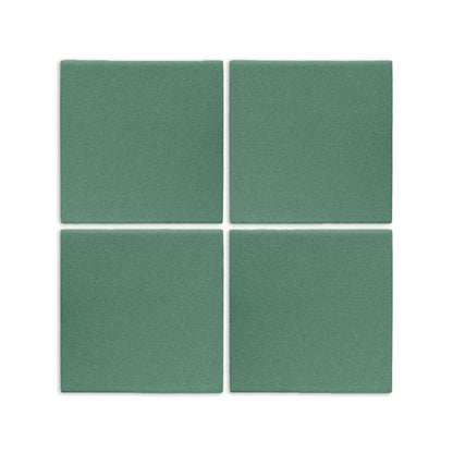 Four square cilantro green clay tiles by Clay Imports with a speckled matte texture, arranged on a white surface.