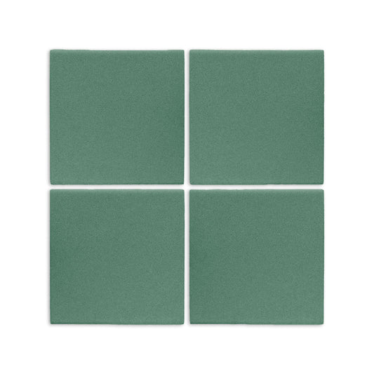 Four square cilantro green clay tiles by Clay Imports with a speckled matte texture, arranged on a white surface.