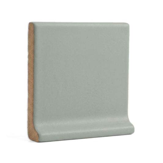 Agave solid cove base tile trim by Clay Imports, with a curved profile and speckled matte surface.