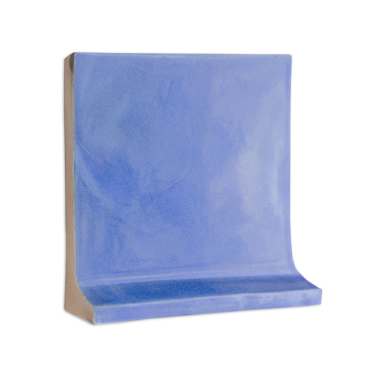 Blue cove base solid tile trim by Clay Imports, featuring a smooth finish and curved bottom edge.