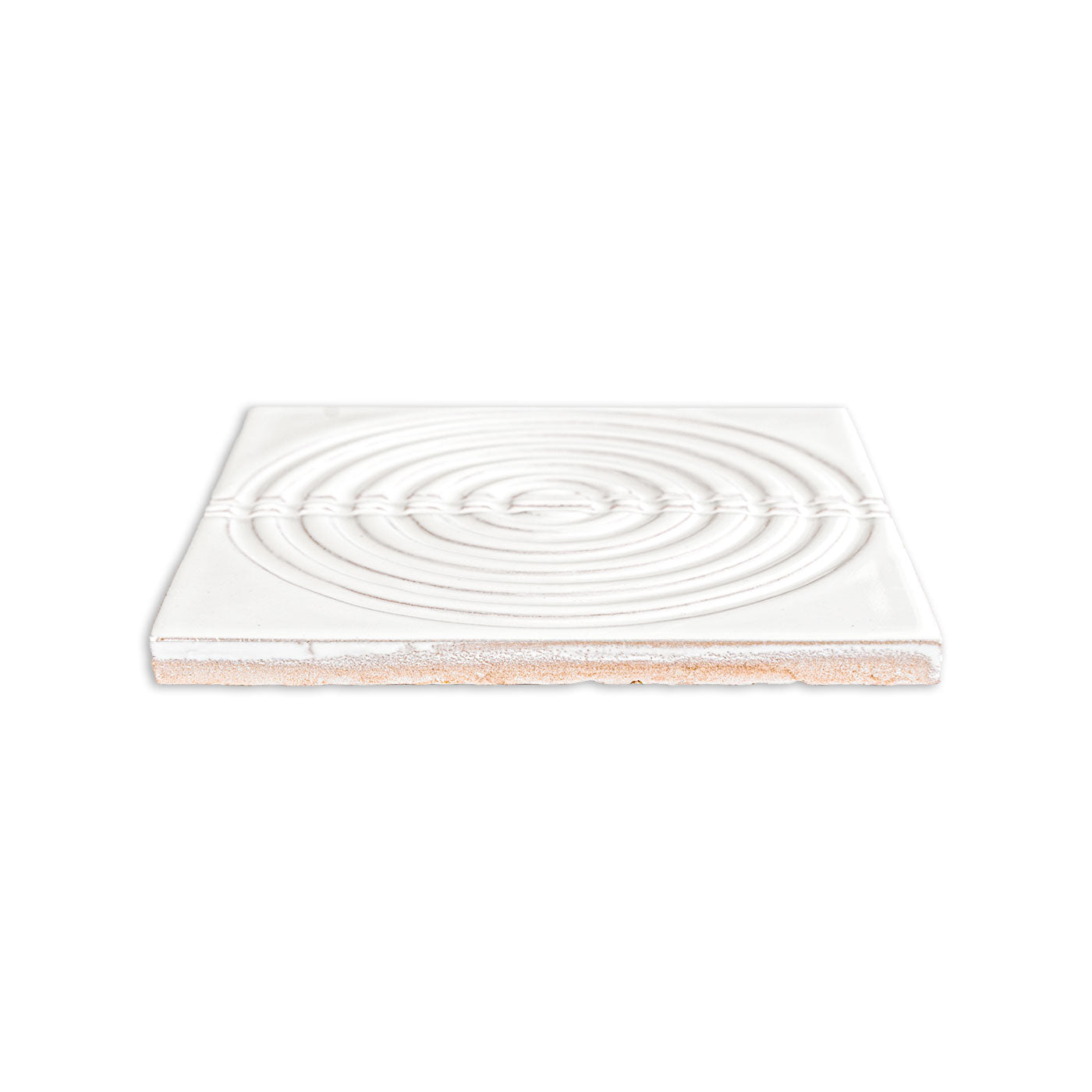 Glossy white ceramic tile by Clay Imports with concentric ripple pattern and textured horizontal band, revealing terracotta edge.