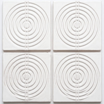 White Perla Gloss ceramic tile by Clay Imports with raised concentric circles and a central vertical square pattern.