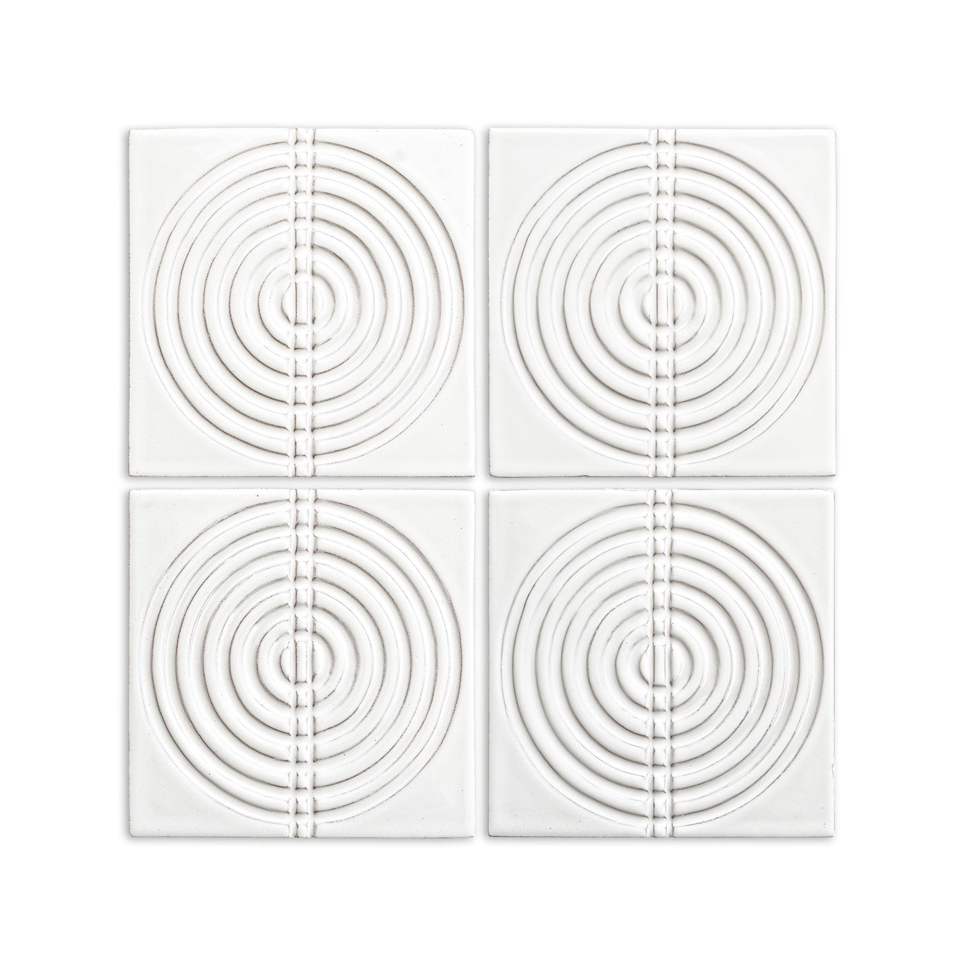 White glossy 6x6 tiles by Clay Imports with a raised pattern of concentric circles bisected by a vertical segmented line.