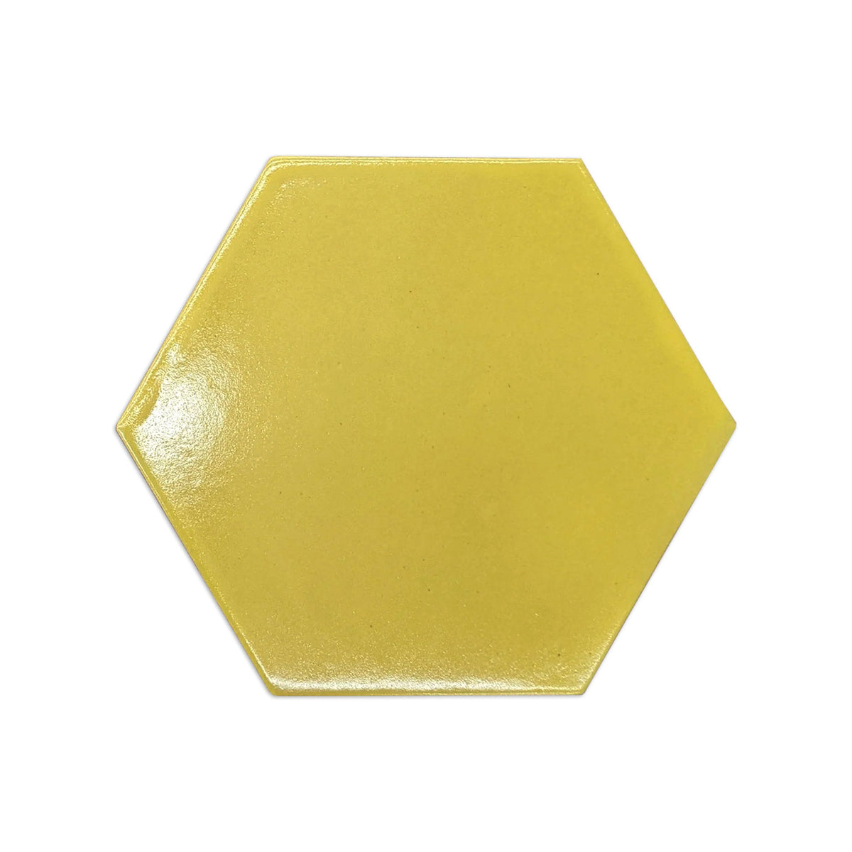 A glossy yellow hexagonal ceramic tile reflects light evenly against a plain white background.