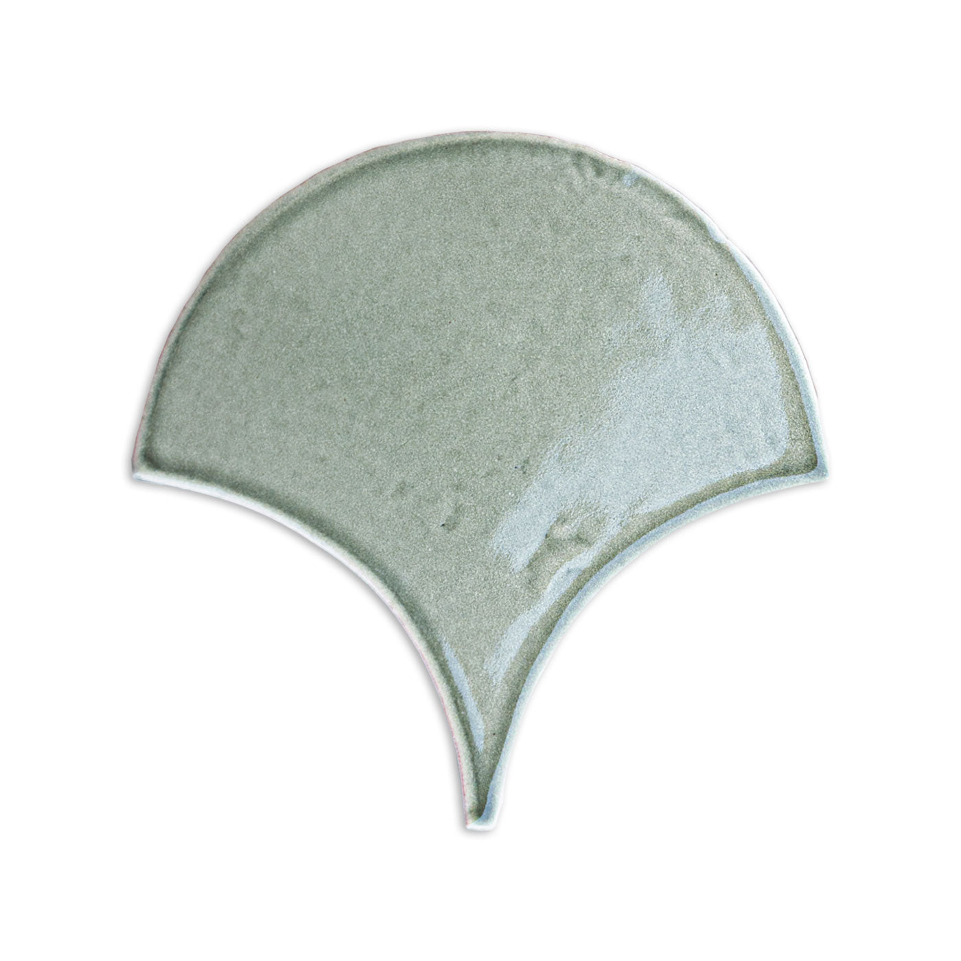 Pale sage green fan-shaped tile by Clay Imports with a glossy, subtly textured surface.