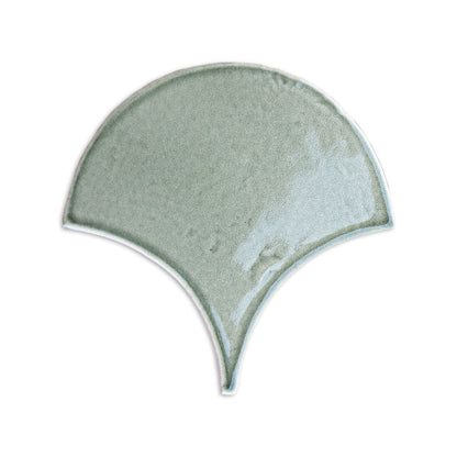 Pale sage green fan-shaped tile by Clay Imports with a glossy, subtly textured surface.