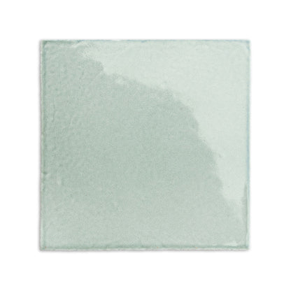Light green glossy 6x6 tile by Clay Imports, with subtle surface variations and irregular edges.